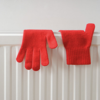 Red gloves on a radiator